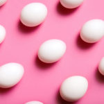 A photo of white eggs on a pink background.