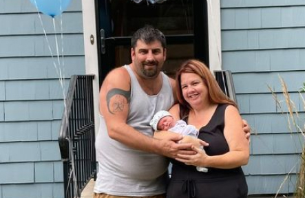 couple holding baby