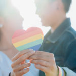 LGBTQ+ couple and rainbow heart