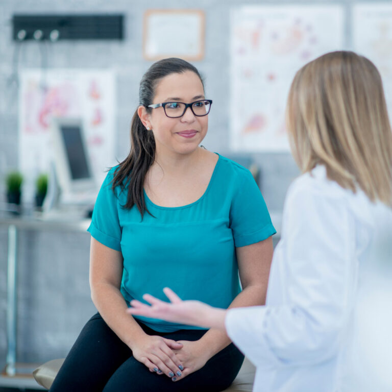 woman in teal at appointment